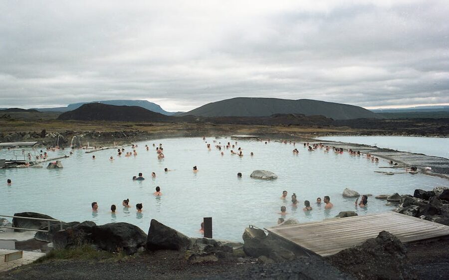 People relaxing in a steaming geothermal pool in Iceland