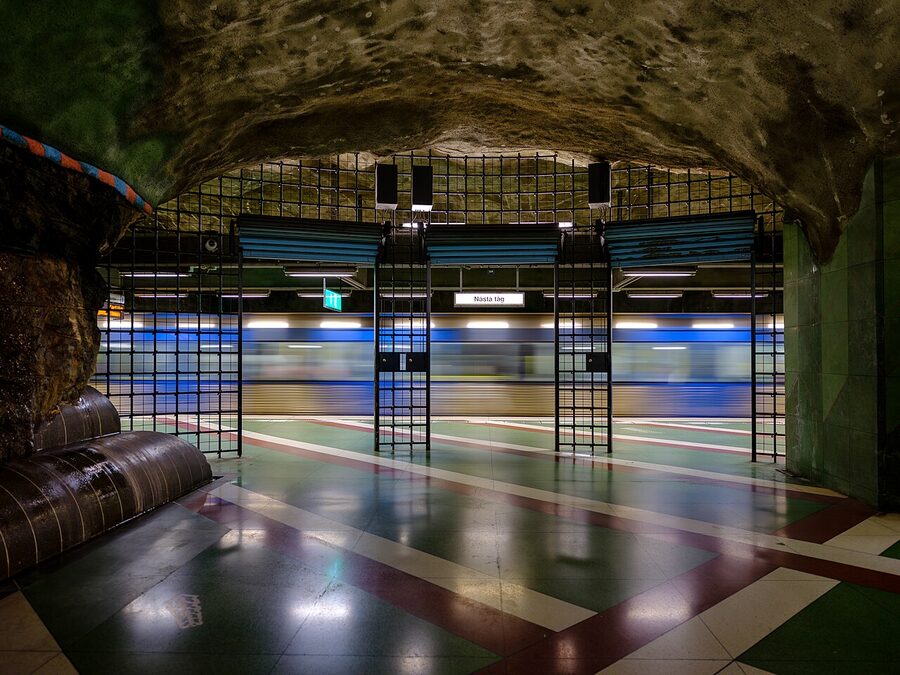 Kungsträdgården metro station with mossy stone walls and the dark green and red surrealist art installation