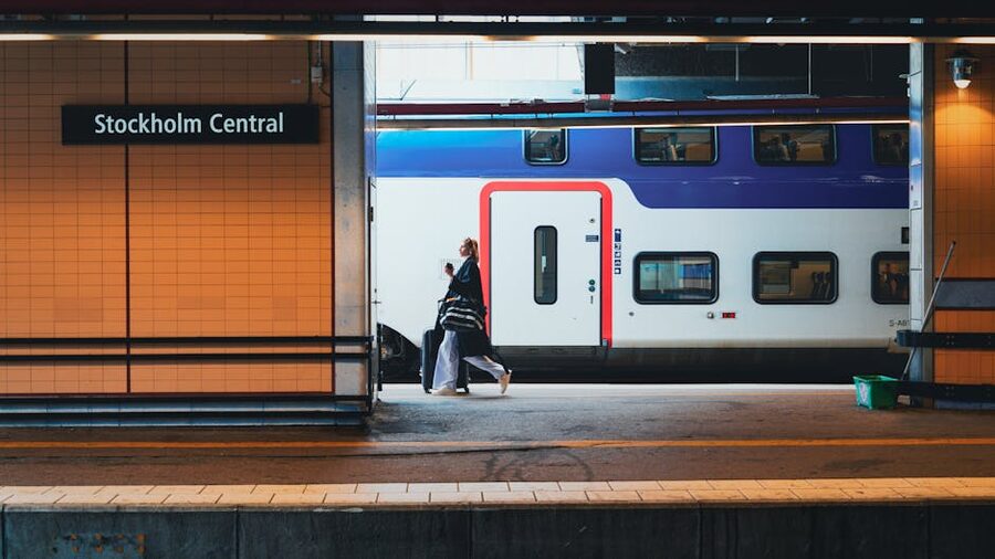 A traveller walks with luggage along a platform at Stockholm Central Station