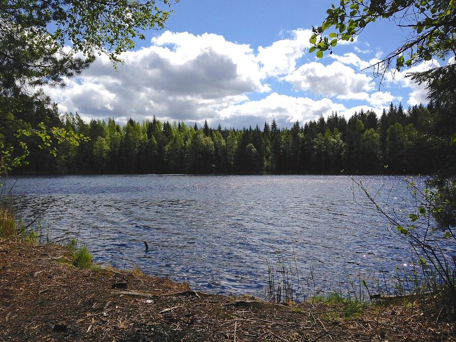 Calm Finnish lake under blue sky in summer