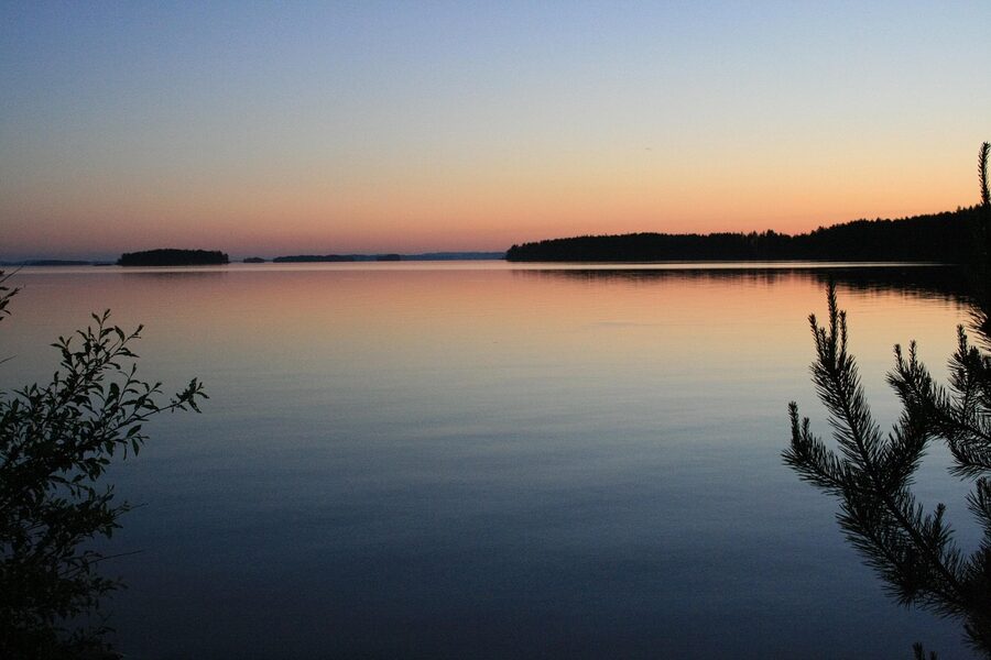 Lake silhouette at midnight in midsummer Finland