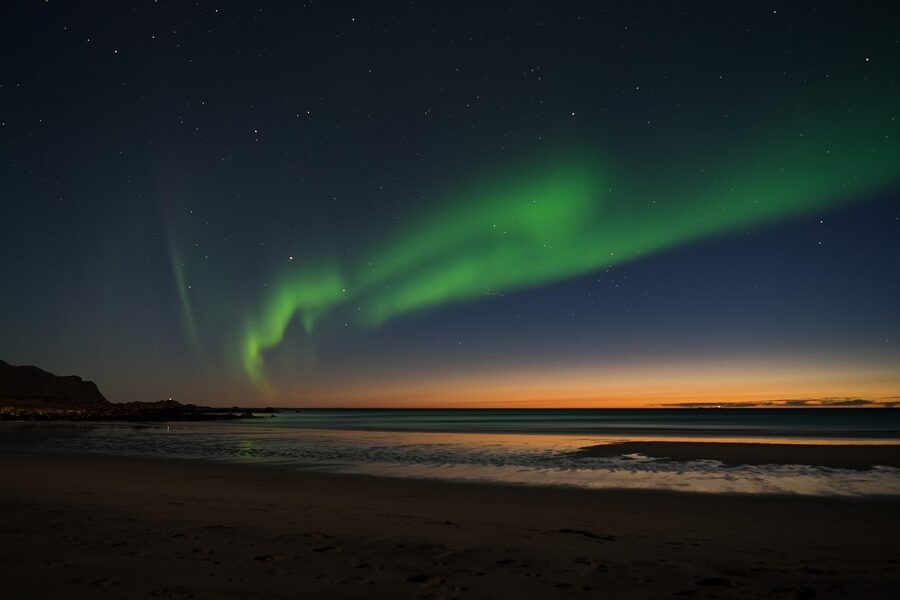Northern lights over snow-covered Lofoten
