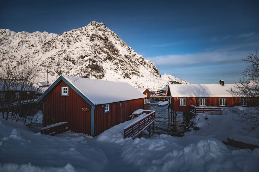 Red rorbu cabins in winter snow