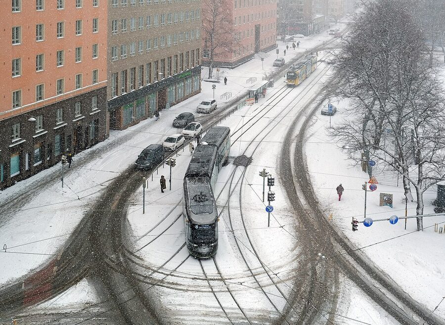 A Helsinki tram in heavy snow on a winter street