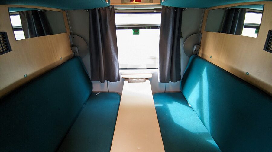 Vy night-train sleeper compartment with table and bed configuration