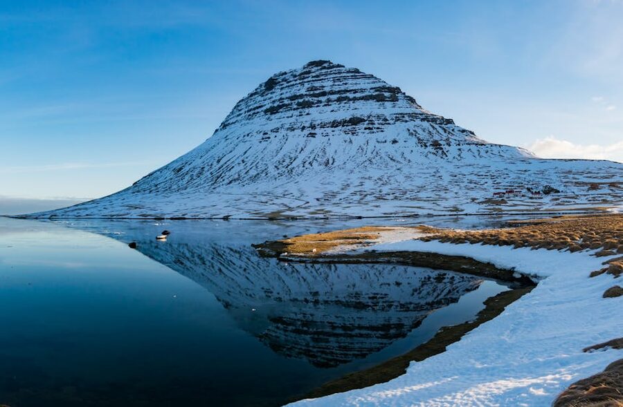 Kirkjufell mountain reflected in serene Icelandic waters