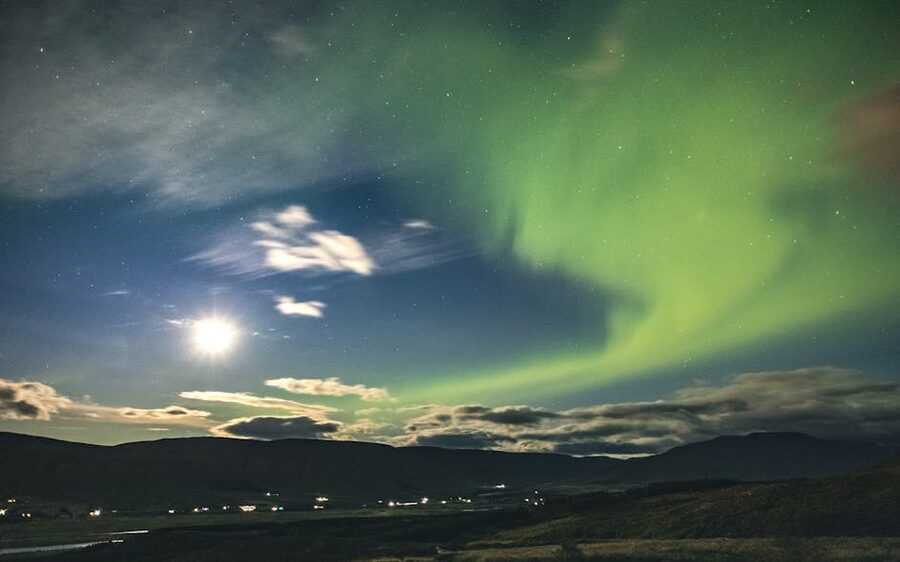 Spectacular Northern Lights display over Iceland's dark winter landscape with a starry sky