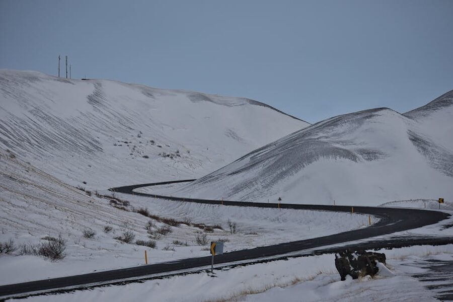 Remote snow-covered mountain road winding through Iceland's Þingeyjarsveit