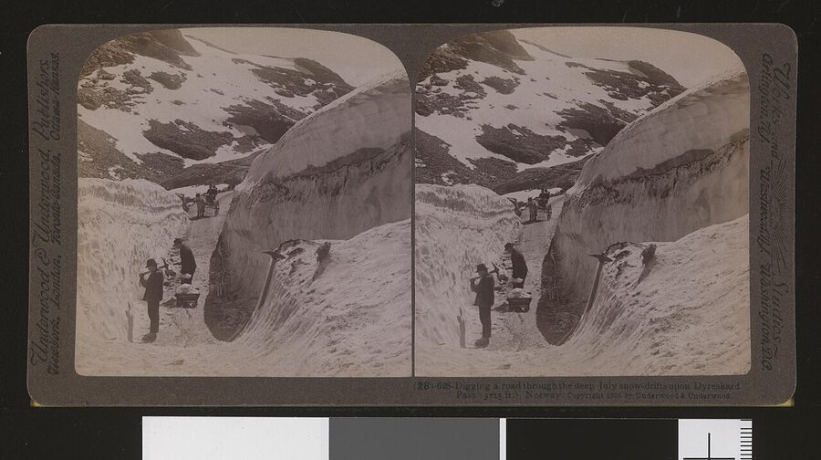 Workers digging a road through deep summer snowdrifts at Dyreskard Pass in southern Norway