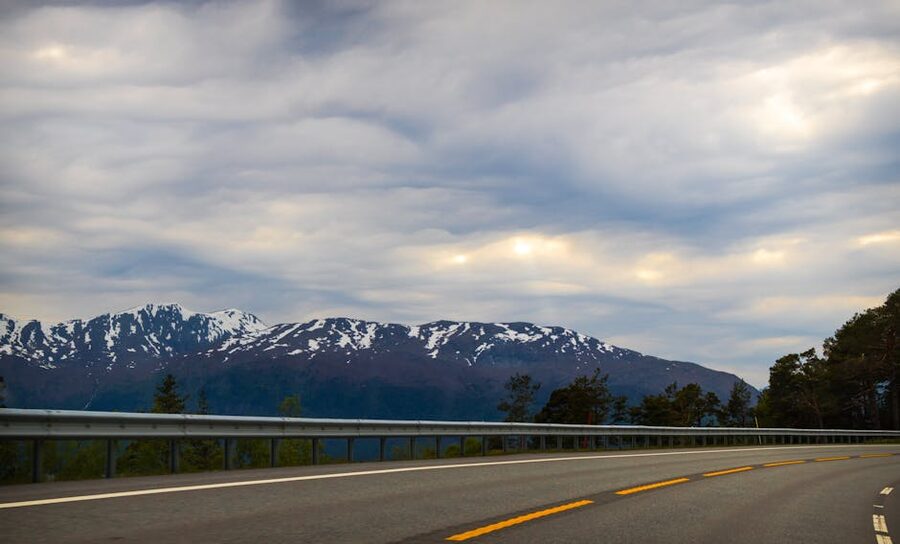 Winding mountain road in Norway between rock walls