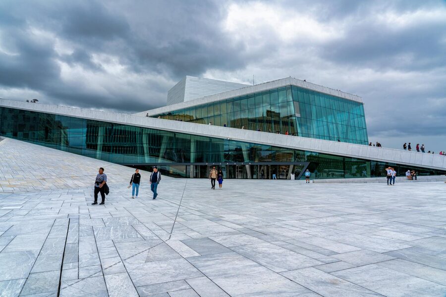 People walking on the sloping roof of the Oslo Opera House