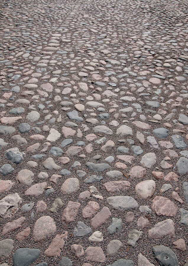 A narrow cobblestone lane in Porvoo Old Town with wooden houses on either side