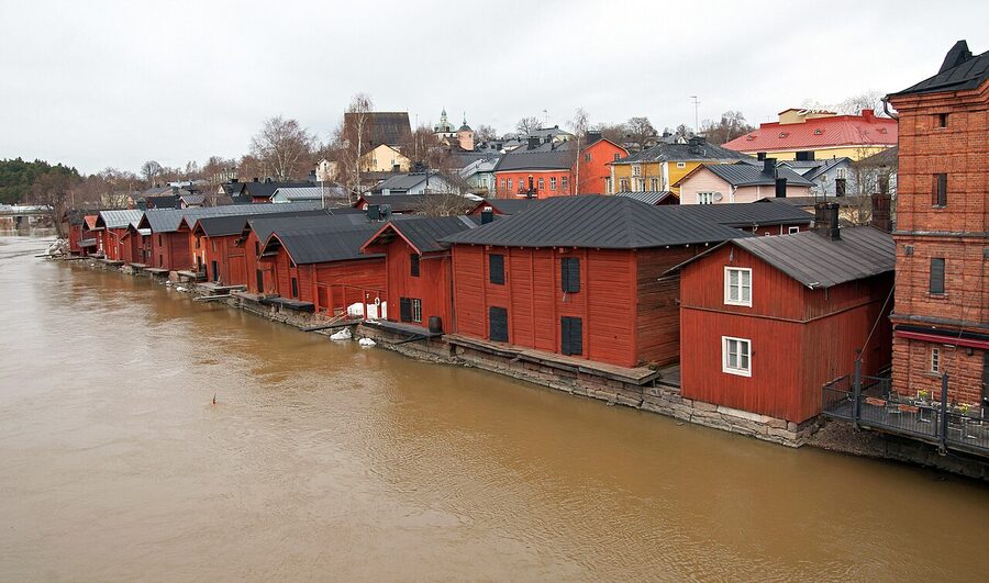 Old Porvoo riverside red wooden warehouses reflected in the Porvoonjoki river