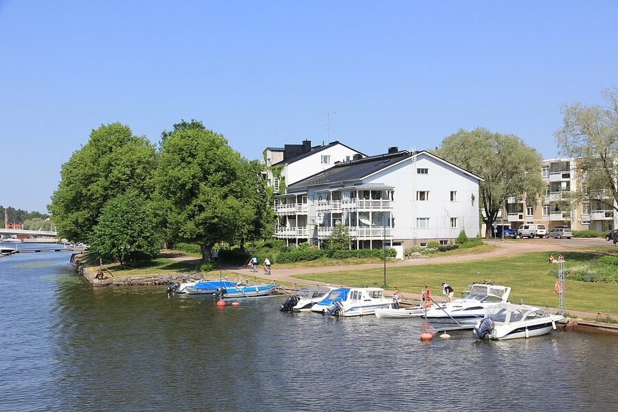 Wooden houses along Jokikatu street in Porvoo with the river bank visible at the end