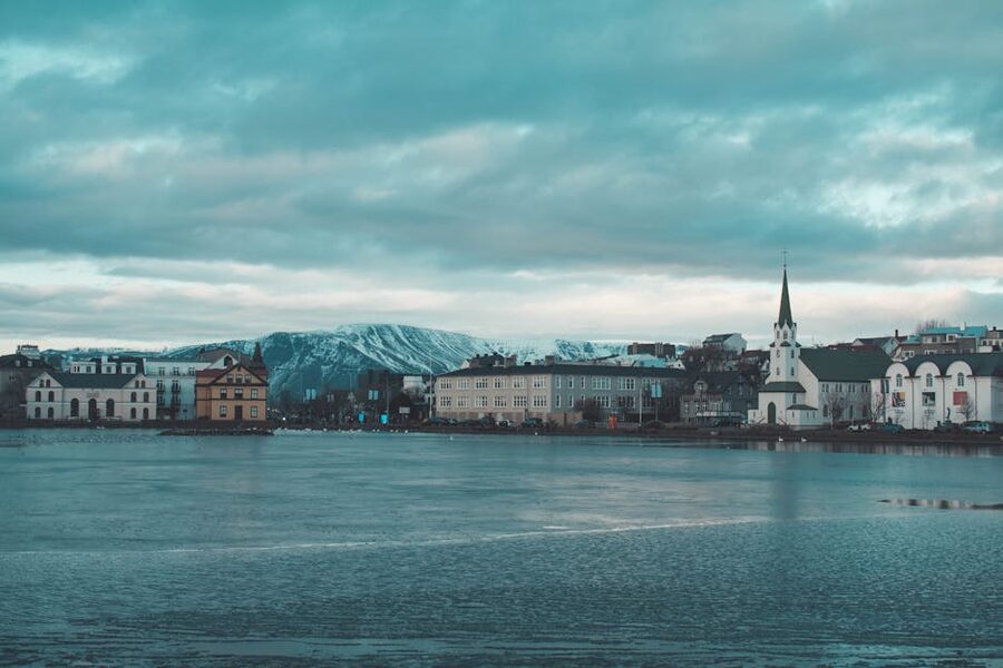 Reykjavik skyline and Tjornin lake under a moody sky