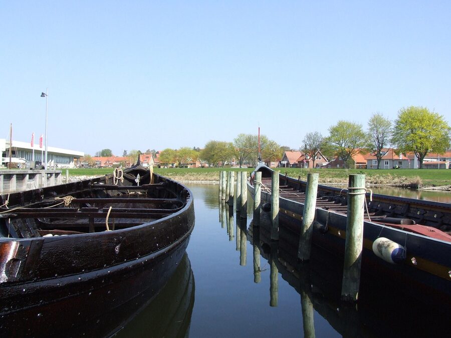 Viking ship at Roskilde harbour with cathedral spires in the distance