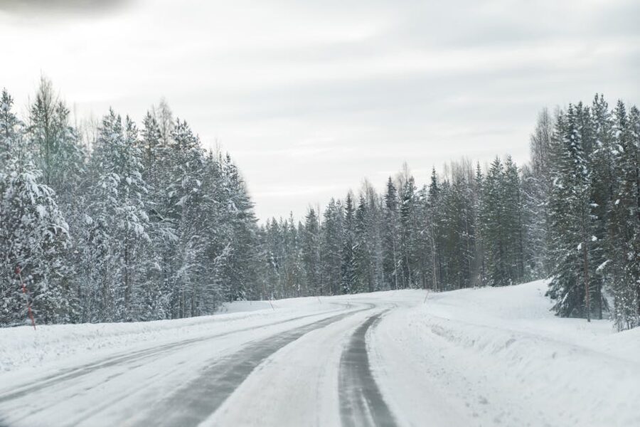 Winter road through snowy forest in Rovaniemi