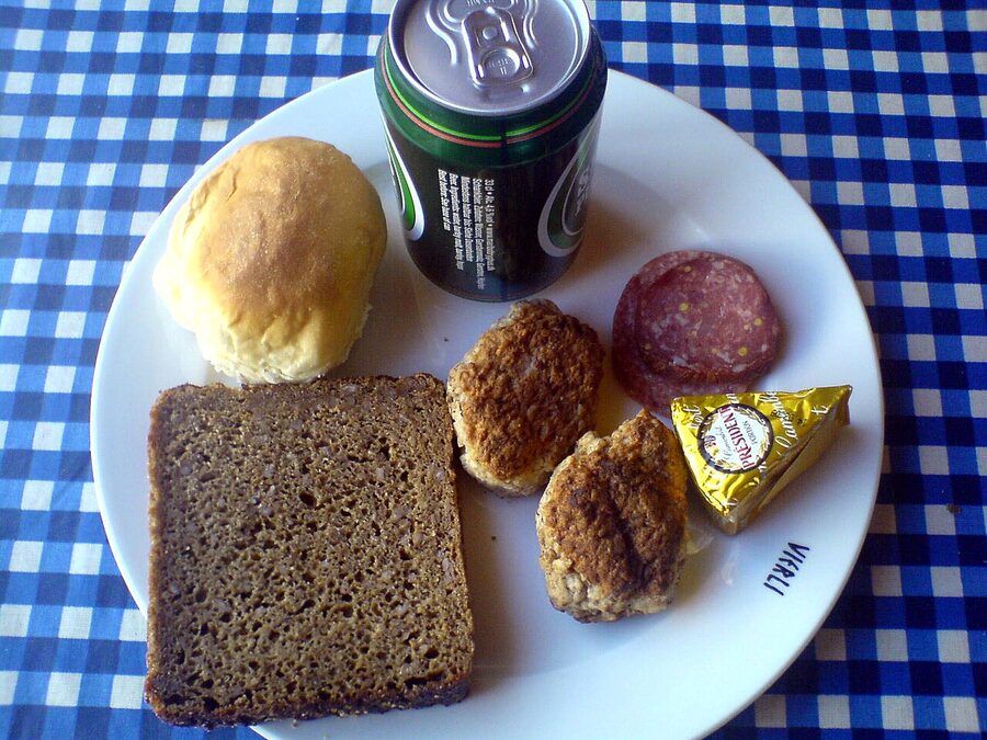 A Danish frokost spread with rugbrød, frikadeller, spegepølse, camembert and beer