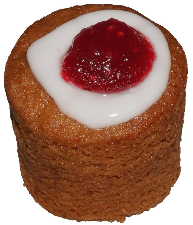 A Runebergintorttu, a cylindrical Finnish almond pastry with white icing and a raspberry jam dot on top