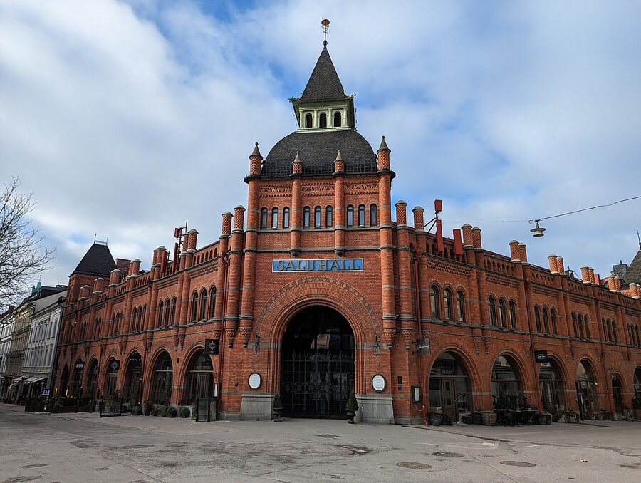 Östermalms Saluhall food hall interior with the brick-and-iron Victorian architecture and stalls