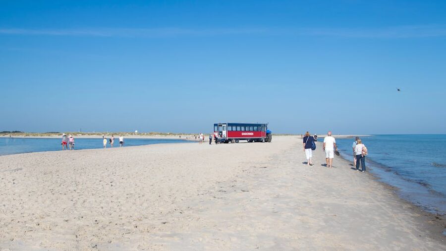 Sandormen tractor bus carrying passengers across Skagen beach to Grenen