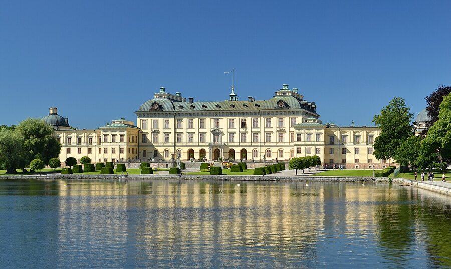 Drottningholm Palace yellow baroque facade with formal gardens and statues