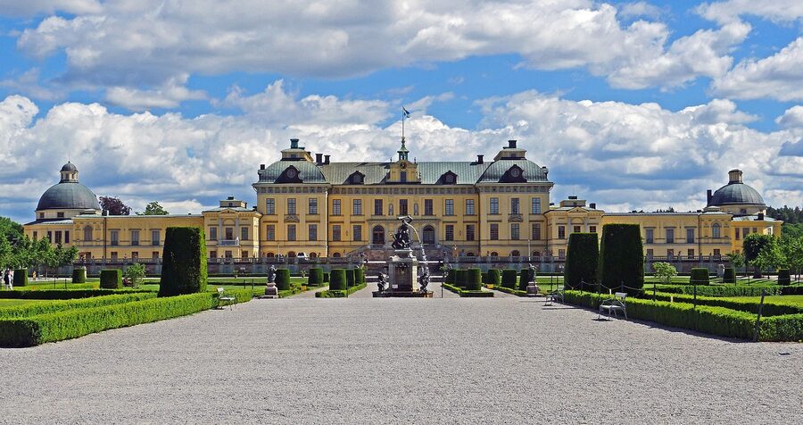 Drottningholm Palace at night with the building illuminated against snow