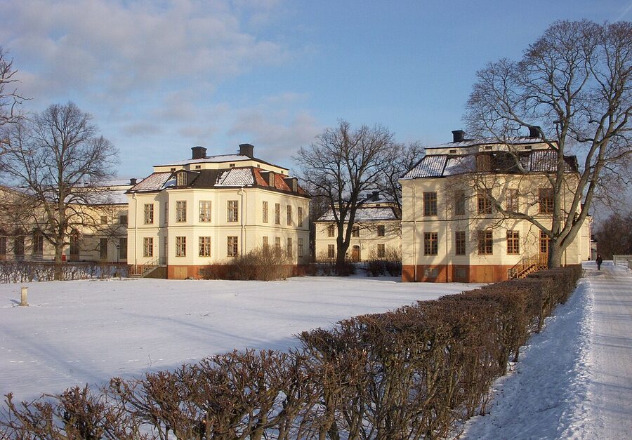 Drottningholm Palace gardens in winter with snow on the parterre and the baroque palace facade behind