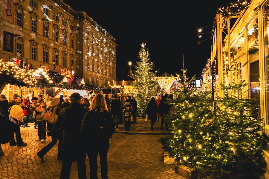 Red wooden Christmas market huts at Stortorget surrounded by colourful old town facades