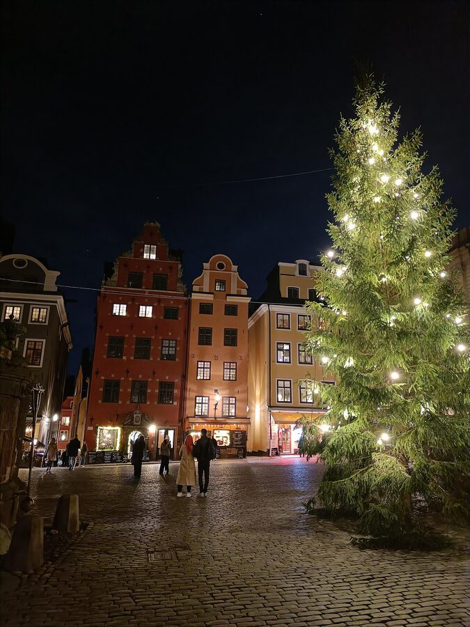 Stortorget square in Gamla Stan with red Christmas market stalls and the colourful 17th-century townhouses behind