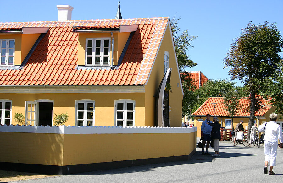 Detail of a Skagen yellow house showing ochre paint and white-trimmed red tiles