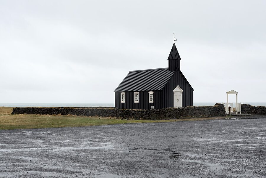 Búðakirkja in spring with mountains and patches of snow