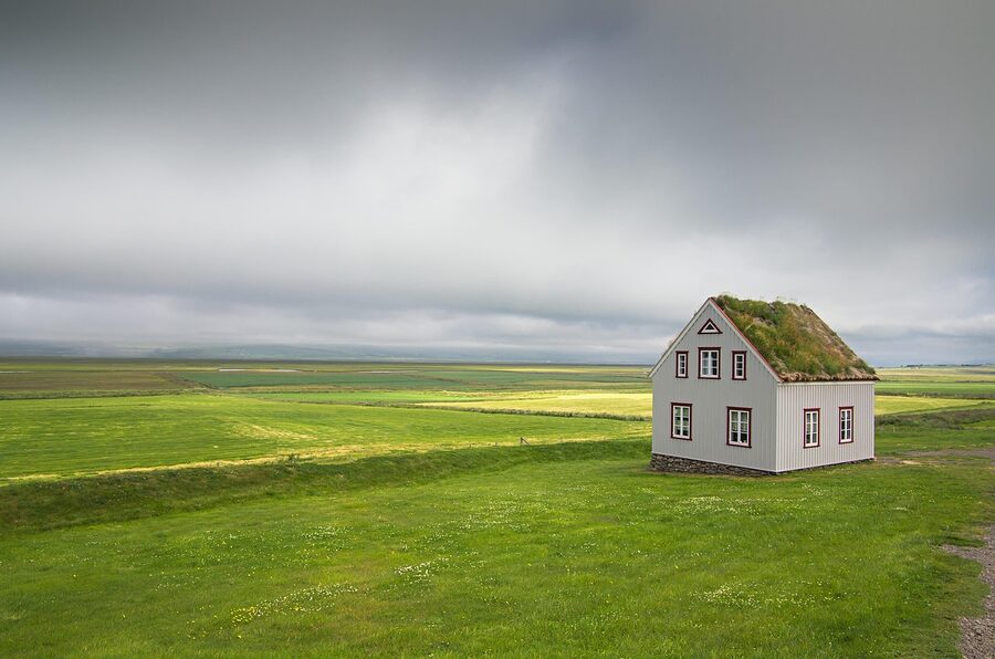 Iceland landscape with clouds and old wooden house