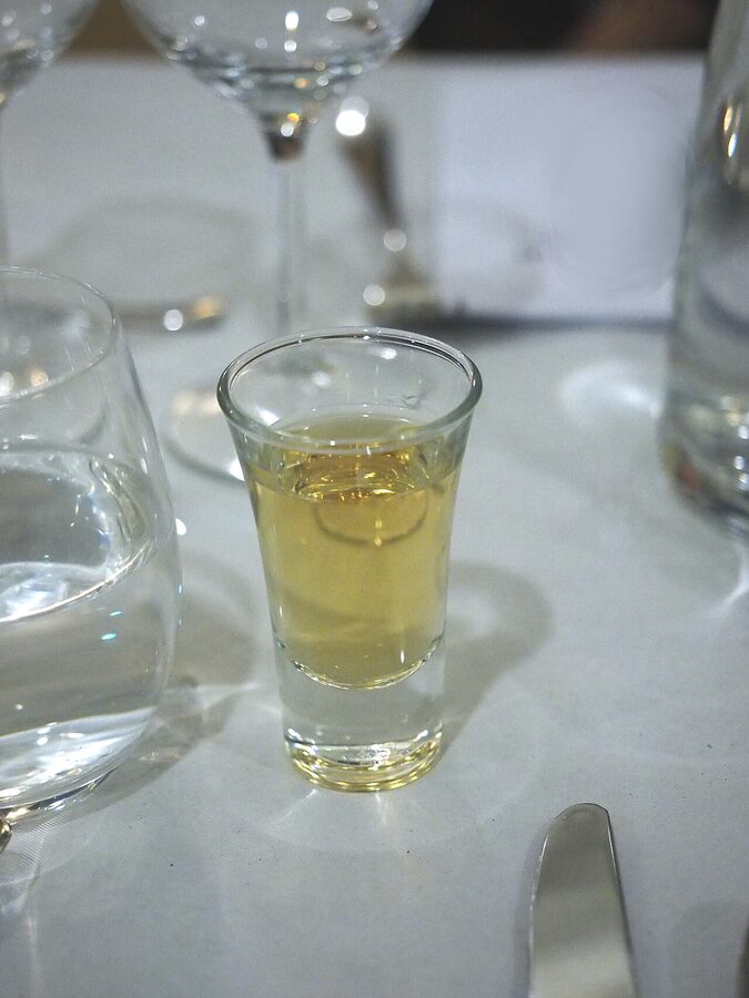 A row of small glasses of cold akvavit (snaps) ready for a Danish lunch
