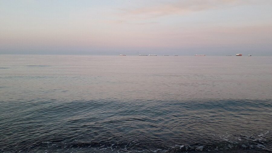 Cargo ships at sunset off Sønderstrand beach in Skagen