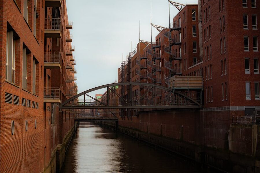 Bridge across a Speicherstadt canal with brick warehouses on both sides