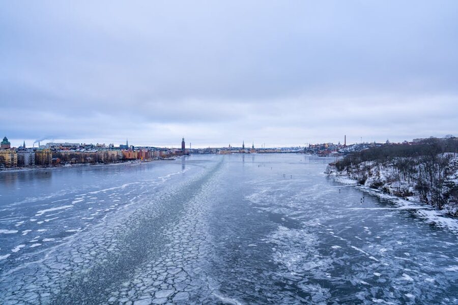 Stockholm in winter with snow on rooftops and a frozen Lake Mälaren in foreground