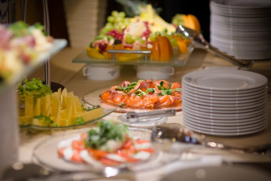 Buffet table with smoked salmon, fruit and cheese