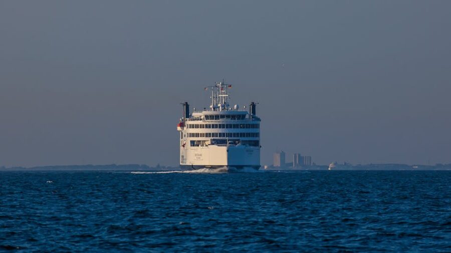 Ferry approaching a city at twilight