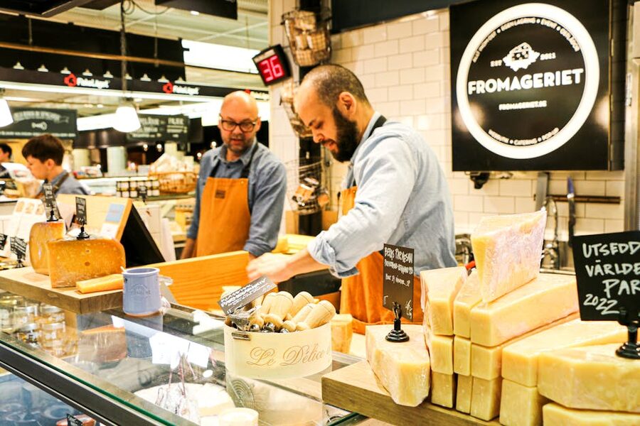 Stockholm food-market sellers behind a cheese counter