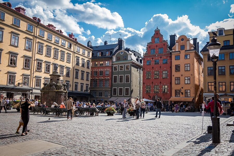 Stortorget Stockholm with painted yellow, red, and orange facades against a blue sky