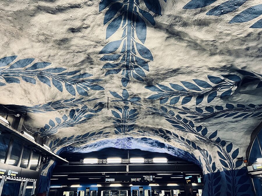 T-Centralen Stockholm metro station with the iconic blue painted vine motif on the white-washed cave ceiling