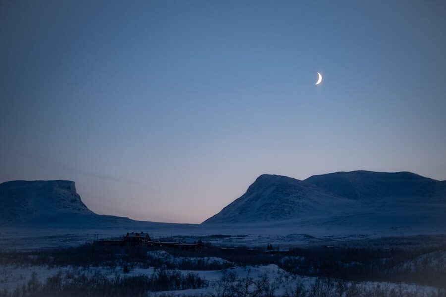 Winter twilight over Abisko with a crescent moon