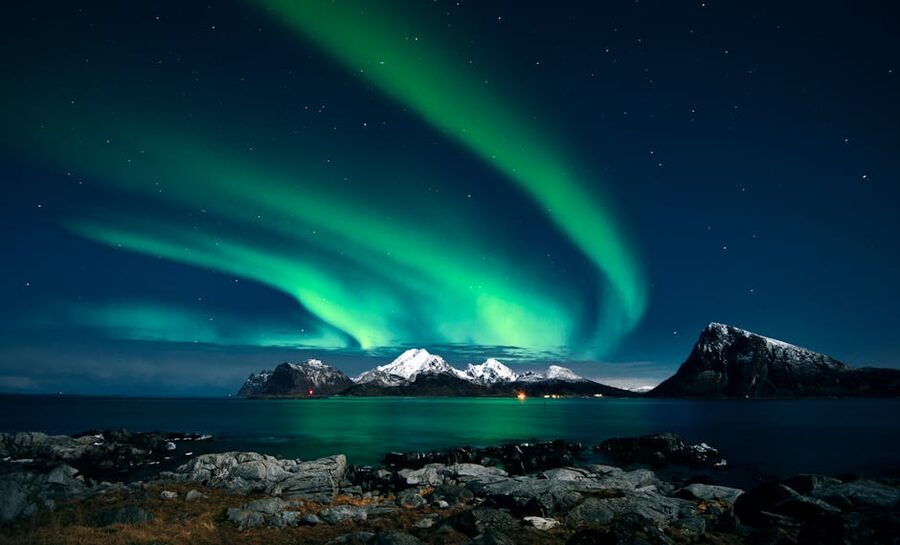 Aurora over snowy Lofoten fjord