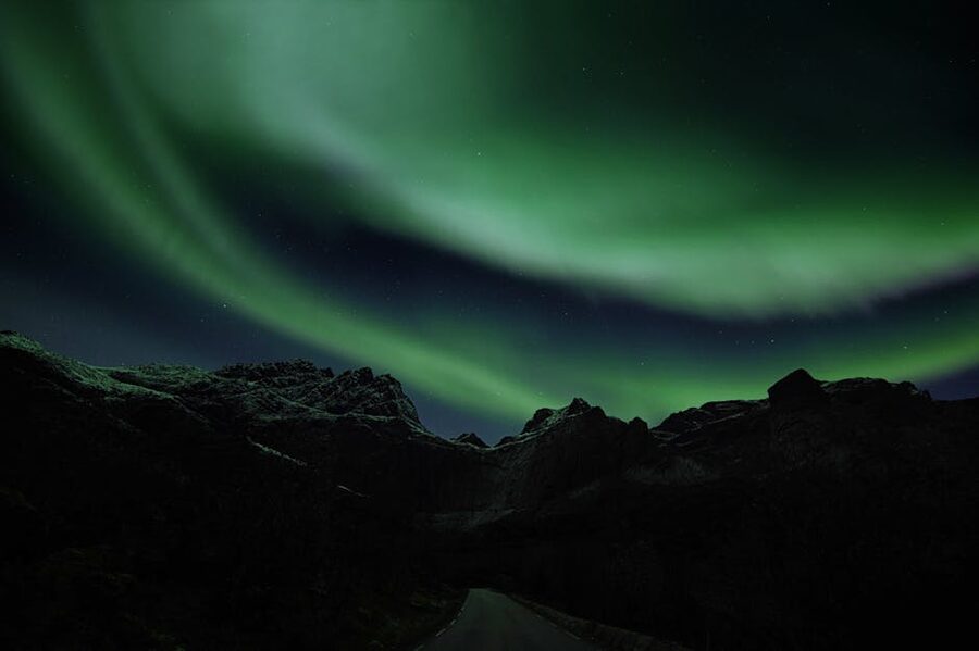 Aurora over rugged Norway mountains