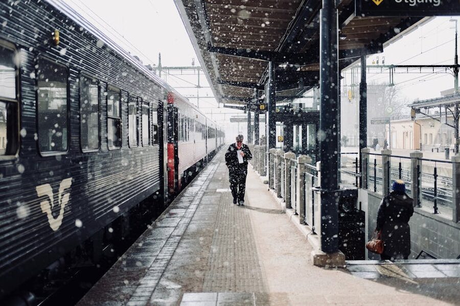 Commuters on a snowy Swedish train platform
