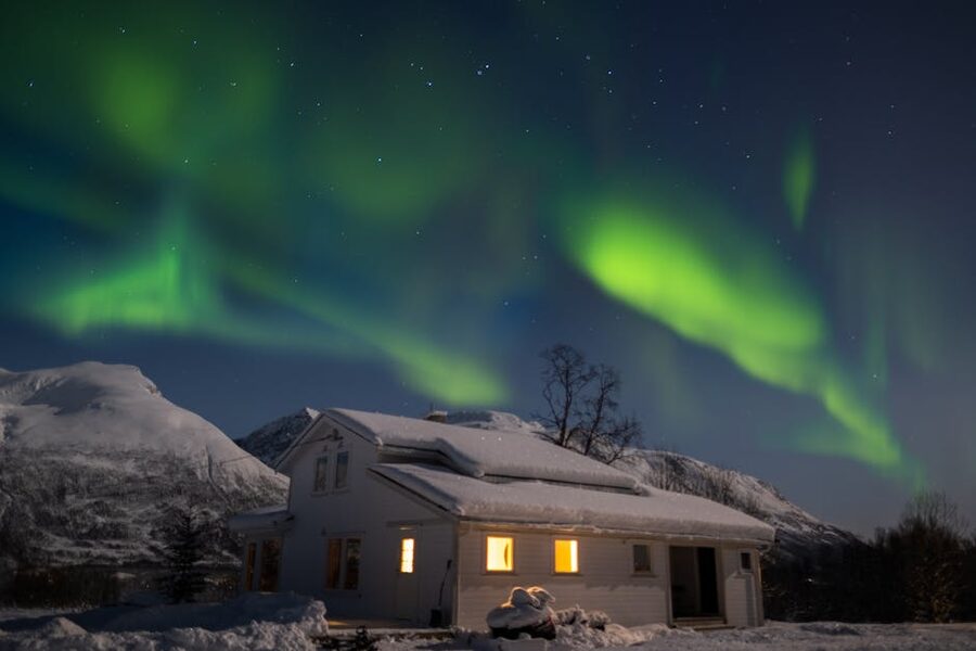 Aurora over a snow-covered house in Tromso