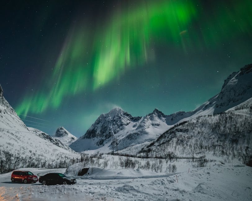 Northern lights over Tromso mountains and snow