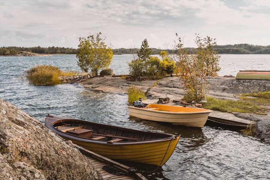 Wooden boats moored on a rocky shoreline in the Turku Archipelago