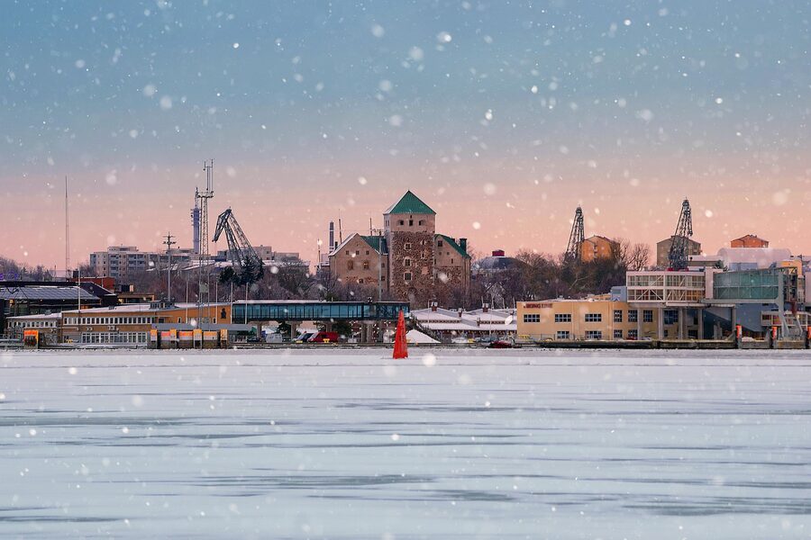 Turku Castle in winter with the river ice frozen and snow on the banks